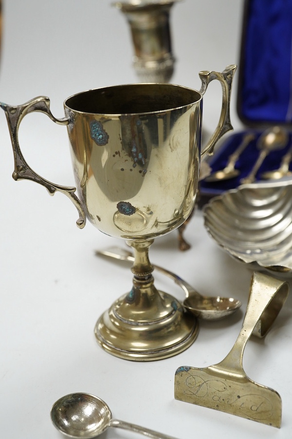 A pair of late Victorian silver dwarf candlesticks, Martin, Hall & Co, Sheffield, 1898, 11.4cm, weighted, a small pair of Irish silver salts, a silver butter shell and six other items including plated ware. Condition - p